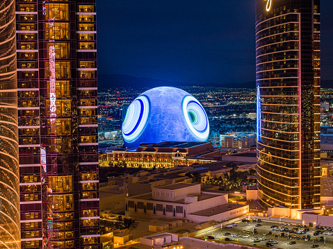 February 21, 2024 - Las Vegas, Nevada: Aerial view of the Sphere at night, framed by the Wynn and Encore hotels. The Sphere is an immersive entertainment venue initially created as a partnership between Madison Square Garden Company and Las Vegas Sands Corporation.