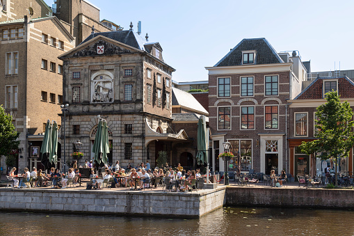 Leiden, Netherlands, June 7, 2021; People enjoy the terrace at the former weighing house - Leidse Waag, in Leiden.