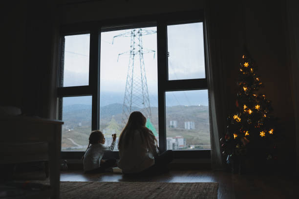 istock Young mother drawing with her little daughter on the window 2043630181