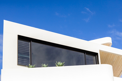 architectural details of a contemporary white building on sunny day