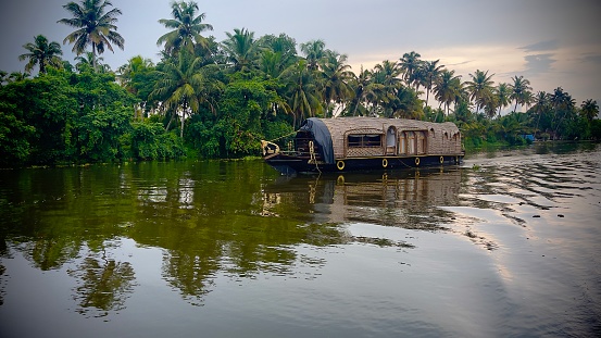 This photo took from kerala( Gods on country) in India. The house boat with coconut tree is on the background