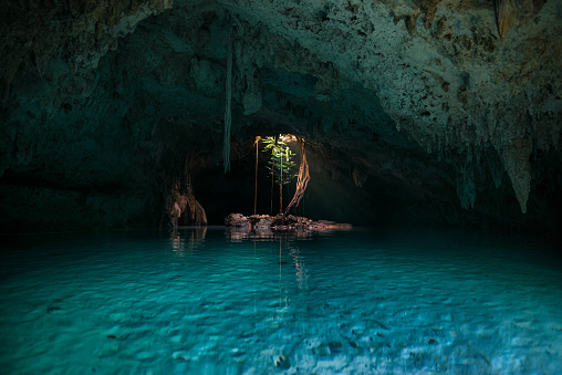 Mysterious cave with blue and green water at Sac Actun cenote