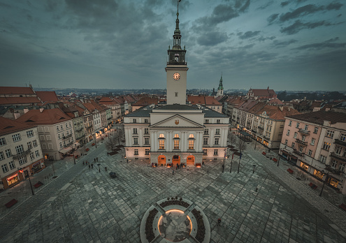 aerial view on old historic city architecture, street during blue hour with dramatic rainy sky