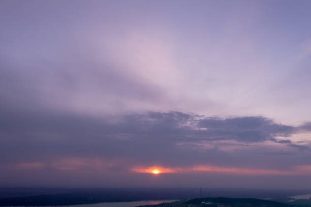 Witness the celestial symphony as the sun bids farewell, painting the sky in hues of orange, pink, and purple. This aerial photo captures the enchanting beauty of the sunset sky, creating a moment of tranquility and awe that is both serene and visually captivating.