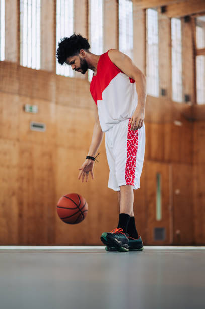 istock A fit tall hispanic basketball player dribbling ball on training. 2043687221