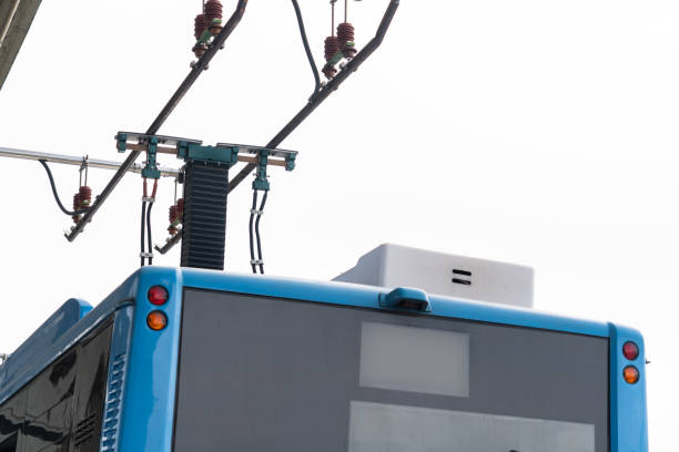 Wires of a trolleybus against the sky at sunset.