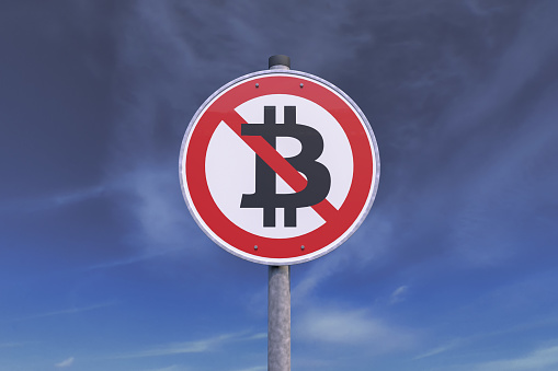 3d rendering of a traffic sign - ban for bitcoin. In the background a gray sky with clouds.