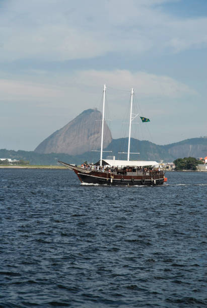 istock Old sloop boat sails through Guanabara Bay on a tourist tour. 2043761925