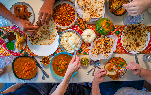 ooverhead view of Tablescape of people eating at an Indian Restaurant