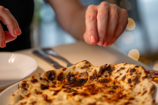 istock female reaching for naan 2043763691