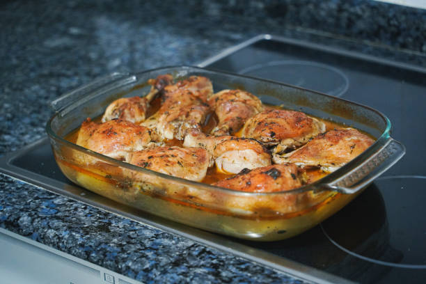 Hot glass oven dish with roast chicken and potatoes, Concept: cooking