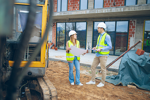 White-collar workers wearing protective helmet works on the building site