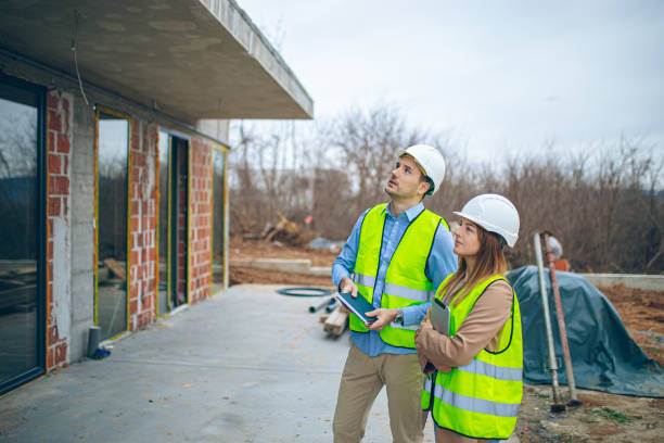 Architects discussing plan at construction site Architects discussing plan at construction site Concrete Contractor.