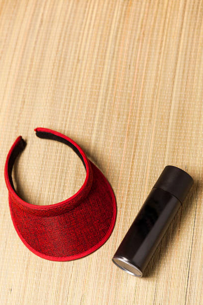 istock Beach mat black spray can and a visor on blue background 2043844942