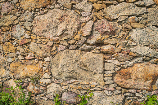 Walls made of multicolor stones , Stone background. Ancient stone wall. Grunge stone wall backdrop. Background of old vintage stone wall. Wall decoration to be beautiful and strong with natural stone.