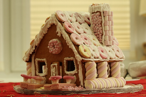 Highly decorated gingerbread house with marshmallows and icing