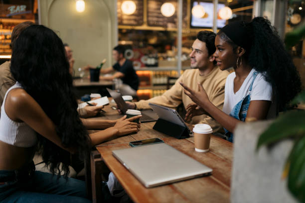 istock Group of young friends talking while sitting at coffee shop 2043985257