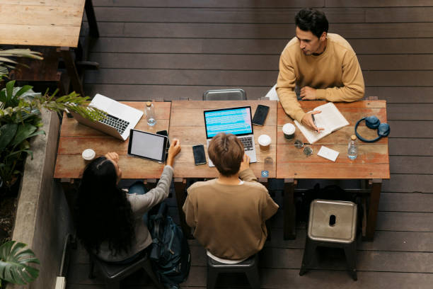 istock Multi ethnic group of friends sitting in cafe and studying together 2043987337