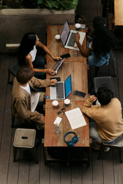 istock Group of diverse young people studying in coffee house together 2043995166