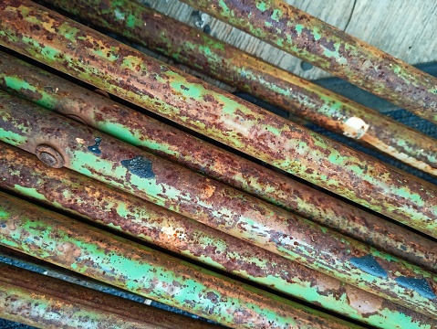 a pile of rusty iron previously painted green