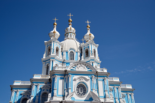 Poltava, Ukraine - April 14, 2021: Holy Dormition Cathedral of the Orthodox Church of Ukraine and a and a festive traditionally decorated sign \