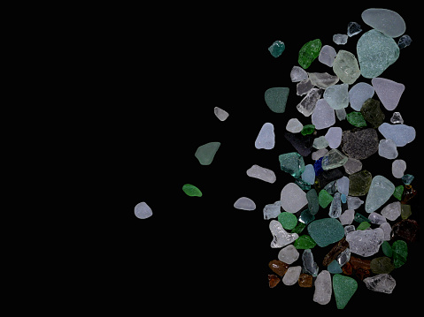 Sea glass isolated on black background.
