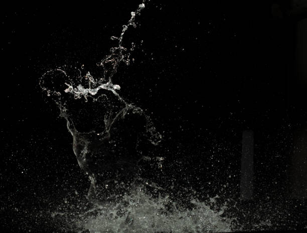 istock Throwing of Water splashes into drop water attack fluttering in wall floor and stop motion freeze shot. Splash Water for explosion texture graphic resource elements, black background isolated 2044014888