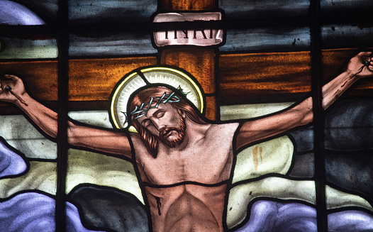 Close-up stained glass representation of the XII Station of the Via Crucis Jesus dies on the Cross. Stained glass in a church in eastern Antioquia