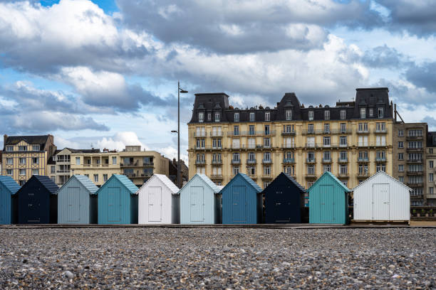 Blue beach huts, in water front on the beach in Dieppe, Normandy, France.August 12, 2023.