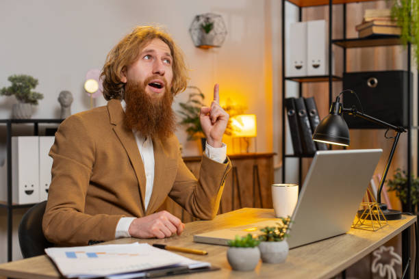 istock Entrepreneur man prepares startup project for presentation finds idea using laptop at home office 2044073030