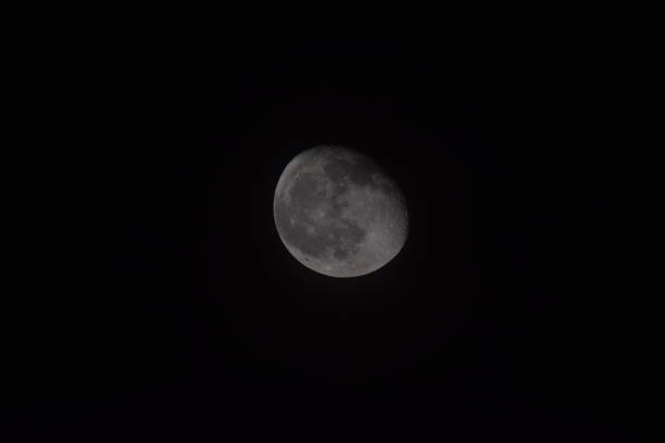 A waning gibbous moon with black copy space.