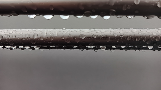 Background Image of water drops on a black feather