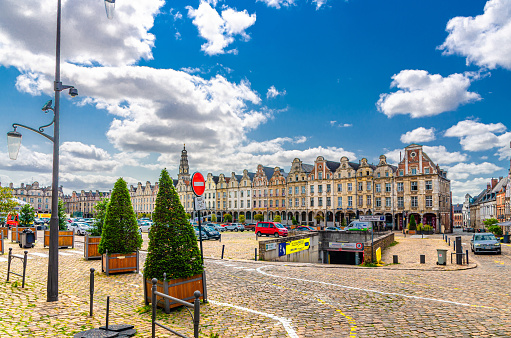 Arras, France, July 3, 2023: Flemish-Baroque-style townhouses buildings on La Grand Place square in historical city center, blue sky, Artois, Pas-de-Calais department, Hauts-de-France Region