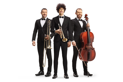 Full length portrait of musicians posing with a trombone, trumpet and a cello isolated on white background