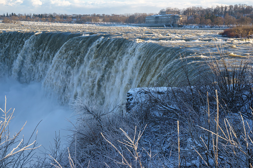 Niagara waterfalls in Canada. The mighty falls is flowing hard when being frozen. The Canada ends has greater looks where the start at its horseshoe. This natural wonder is beautiful in all seasons