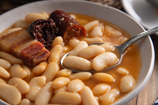 Homemade traditional Spanish fabada from the Asturias region, a white bean stew with chorizo, blood sausage and bacon