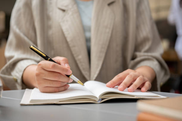 istock A businesswoman taking notes or writing something in her book while working remotely at a cafe. 2044285701