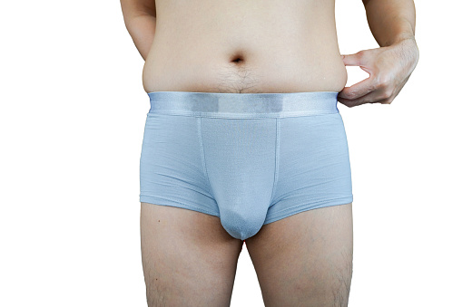 fat man with cellulite on his body isolated on white background. Fat lose, liposuction and cellulite removal concept.