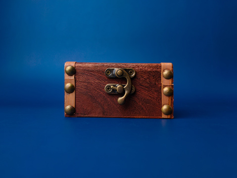 Vintage wooden box on blue background.