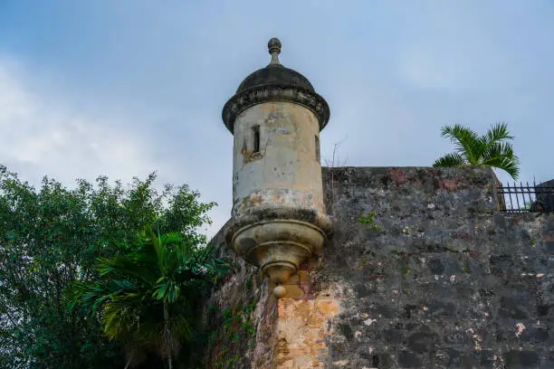 Sentry box along the wall of the Castillo San Felipe El Morro fort in Old San Juan Puerto Rico with palm trees