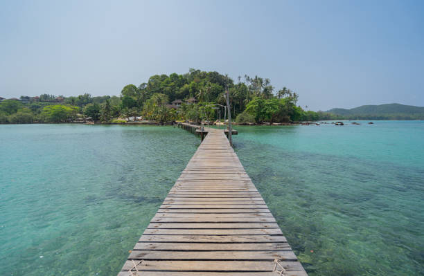 View of the wooden bridge extending into the sea of Koh Mak, Thailand. stock photo