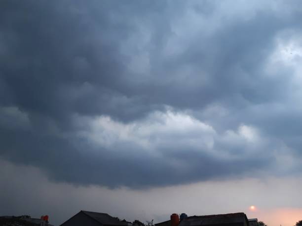 istock The setting sun was followed by thick grey and dark clouds, indicating an impending rainfall 2044528243