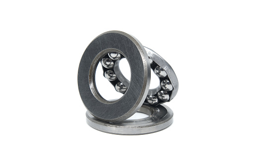 Thrust ball bearing isolated on white background, bearing are stacked upon each other, showcasing the inner structure