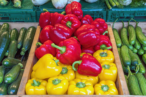 Bell pepper, courgettes and pickles for sale at a market