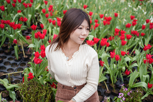 Asian woman in tulip garden