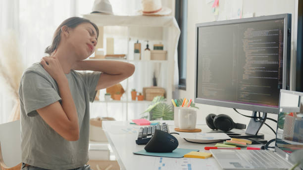 istock Young girl development programmer overwork tired painful shoulder neck muscle from office syndrome solve problem coding program fix database on computer on table in workroom at house office. 2044588491