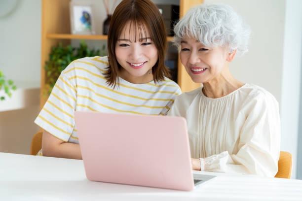istock Senior woman learning how to use a computer in the living room 2044600941