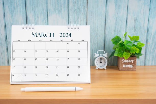 istock March Monthly desk calendar for 2024 year and alarm clock. 2044607821