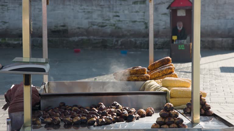 selling grilled corn at the street market