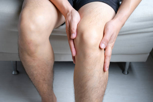 istock Knee pain man He puts his hands on his knees, pain points from osteoarthritis and bone diseases, medical concepts and treatments 2044648431